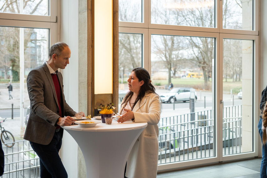 Ein Mann und eine Frau die an einem Tisch stehen und sich unterhalten