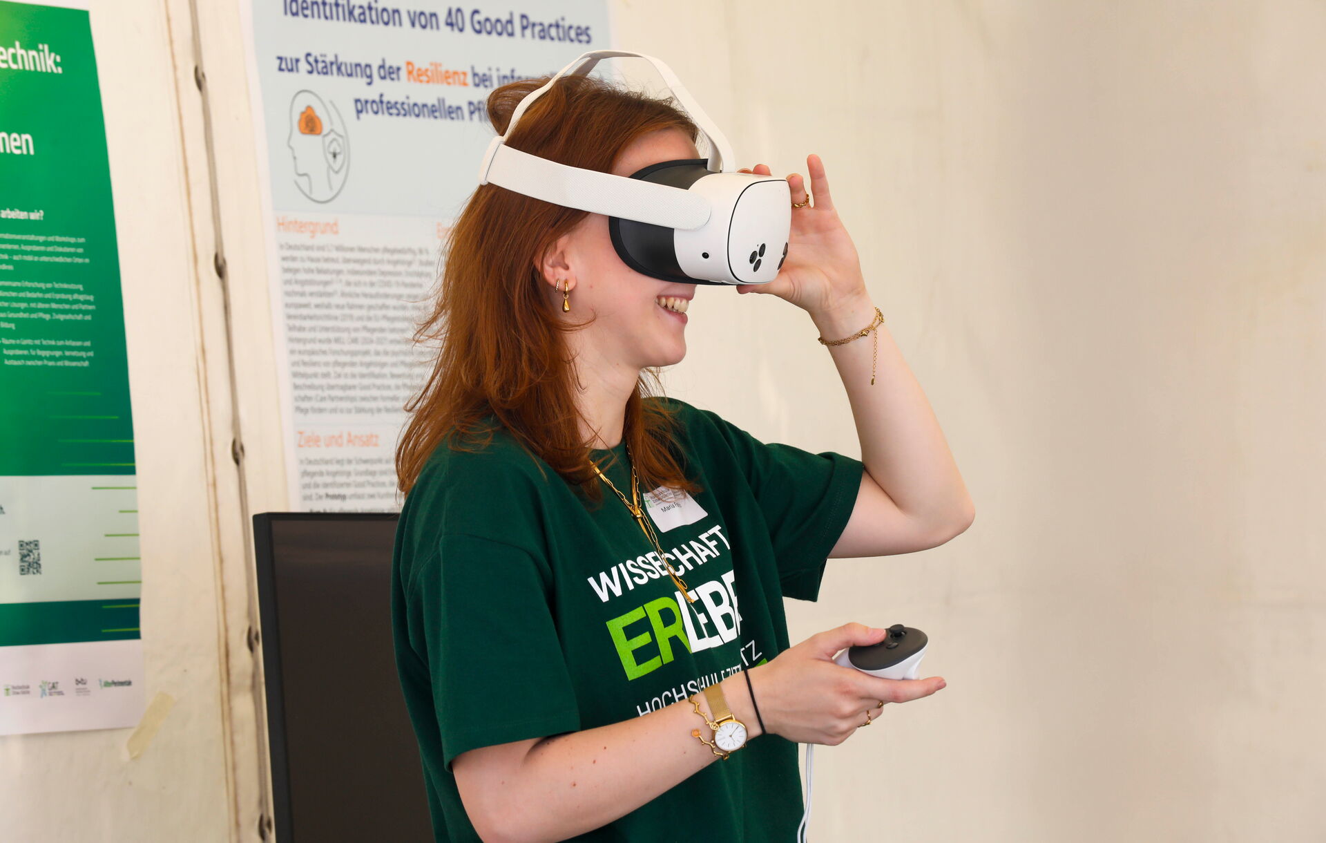 Eine lächelnde Frau trägt eine VR-Brille und hält einen Controller in der Hand.